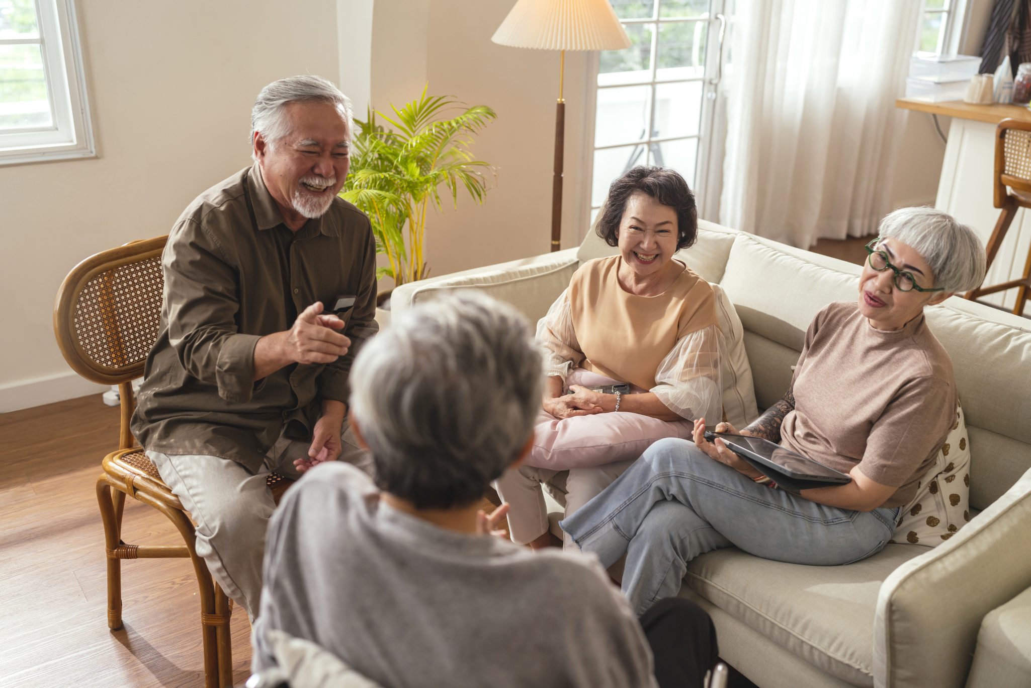 group of seniors laughing together at home