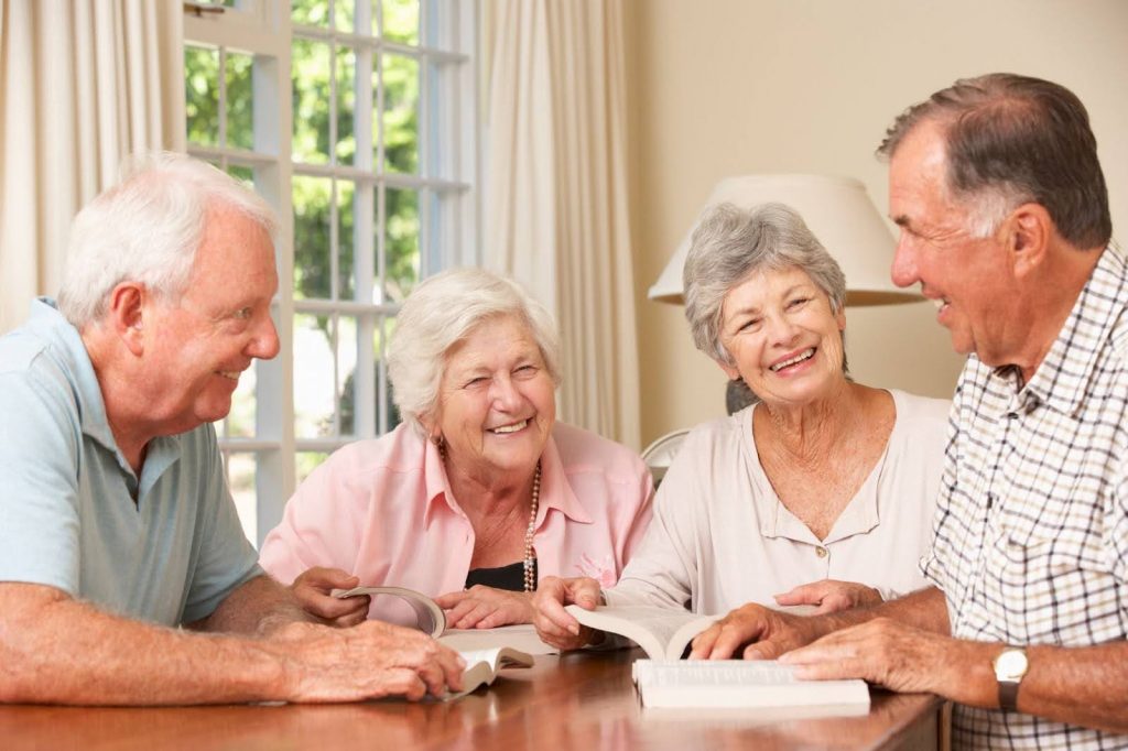 Group of seniors enjoying a book