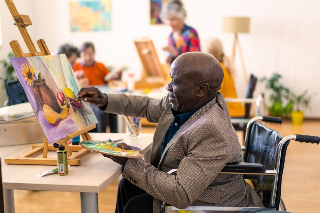 Senior man enjoying a painting class