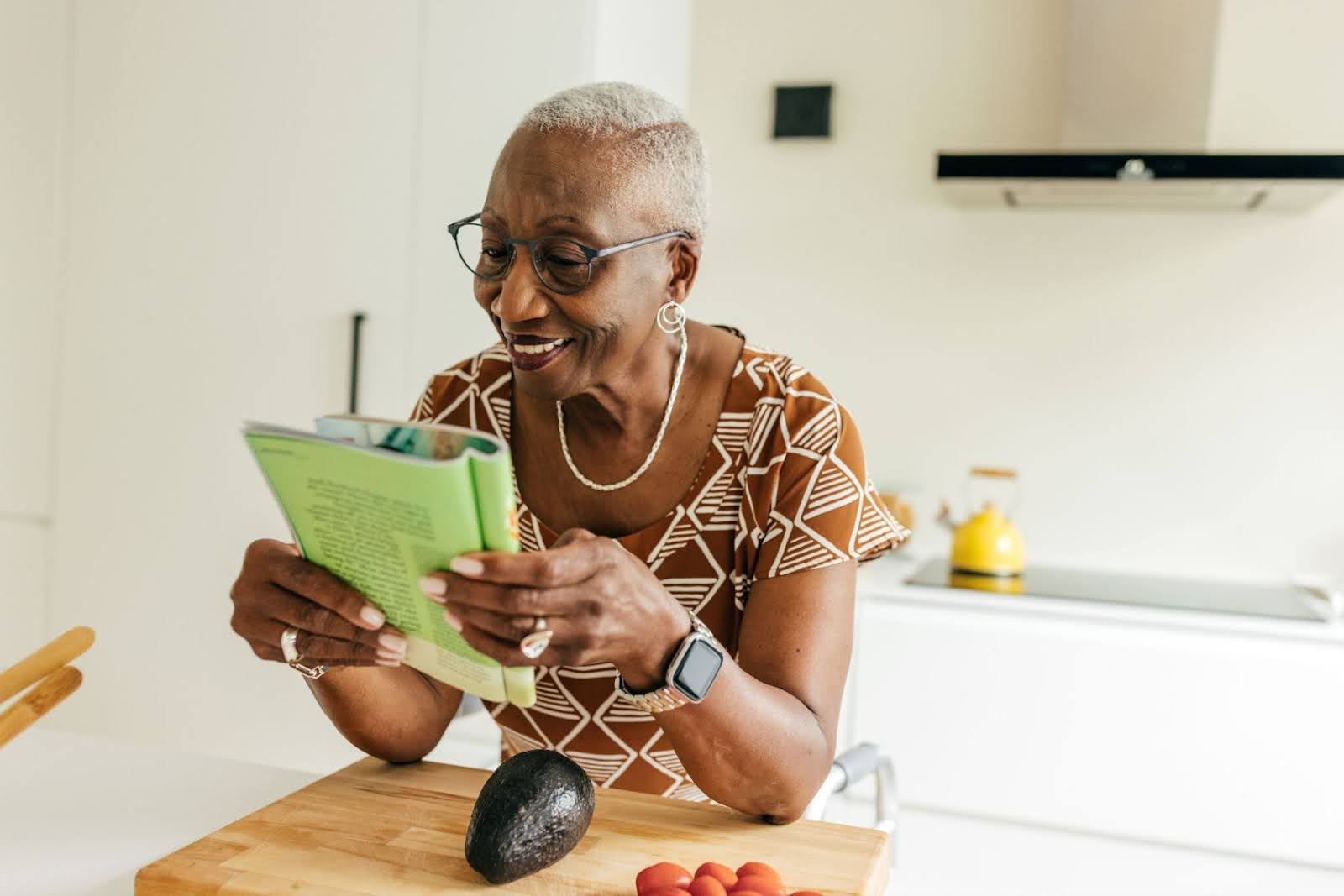 Senior woman reading a magazine smiling