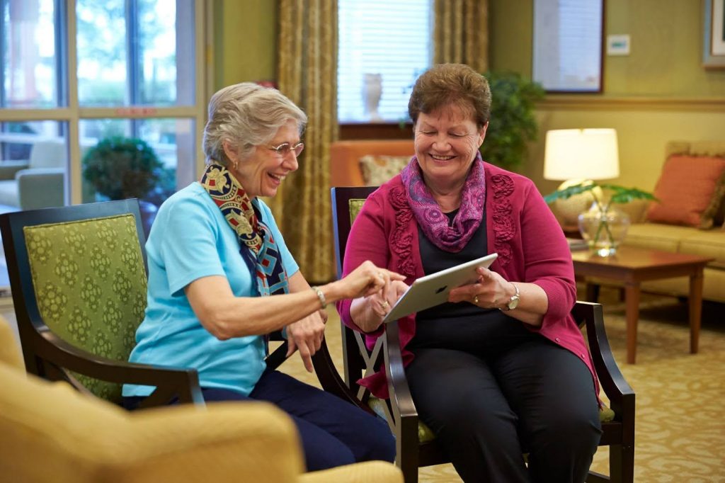 Senior women sharing a magazine