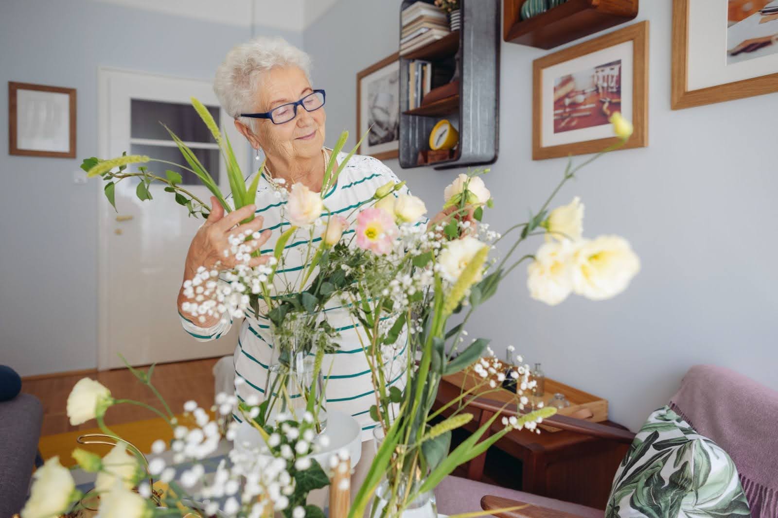 Senior lady putting together a floral arrangement