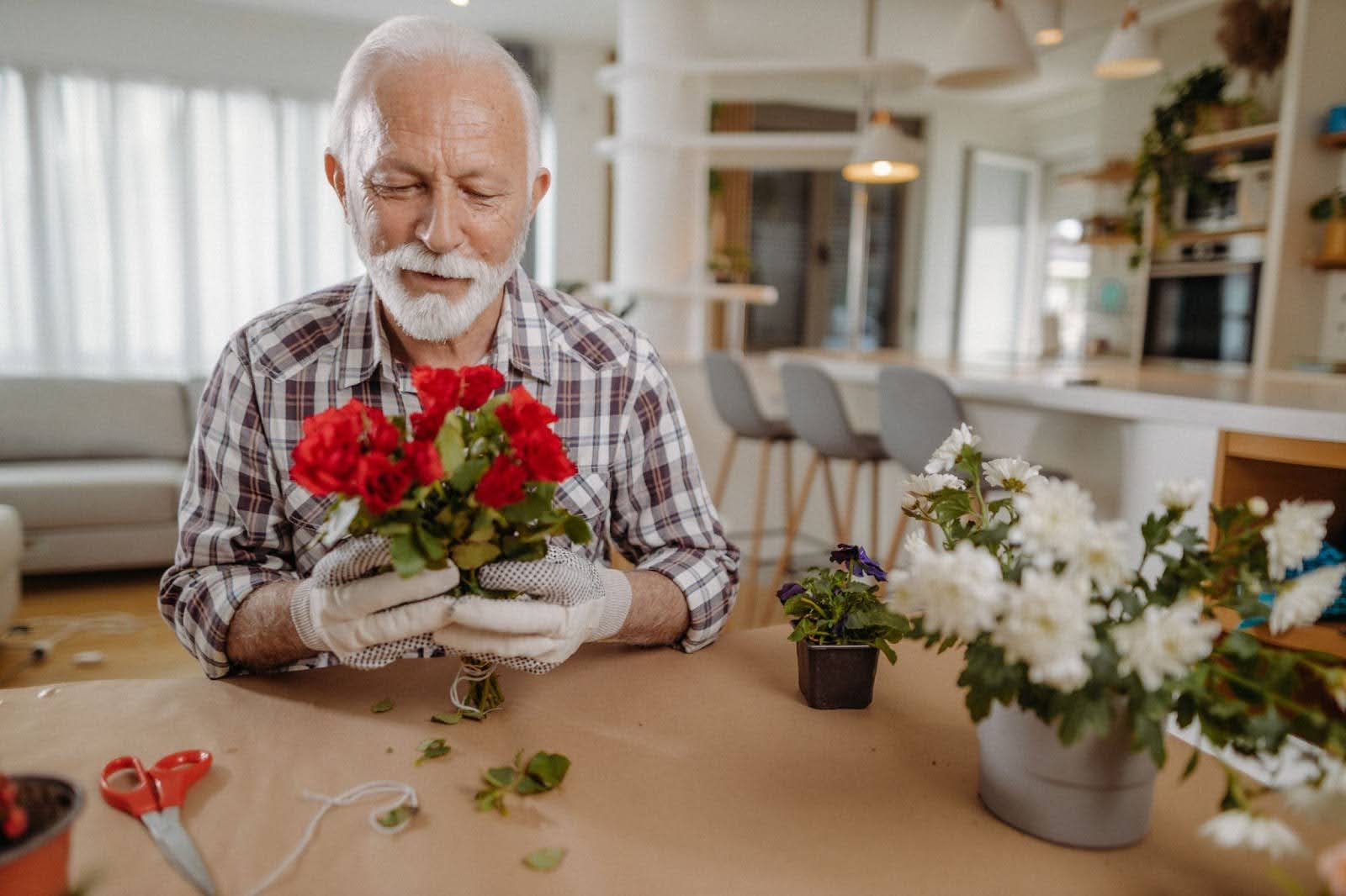 Senior man arranging flowers